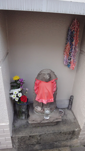 a small neighbourhood shrine statue